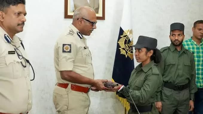 Maoist Malati surrenders her weapon before Kolkata Police Commissioner Ajay Kumar Nand along with Maoist Mangal.